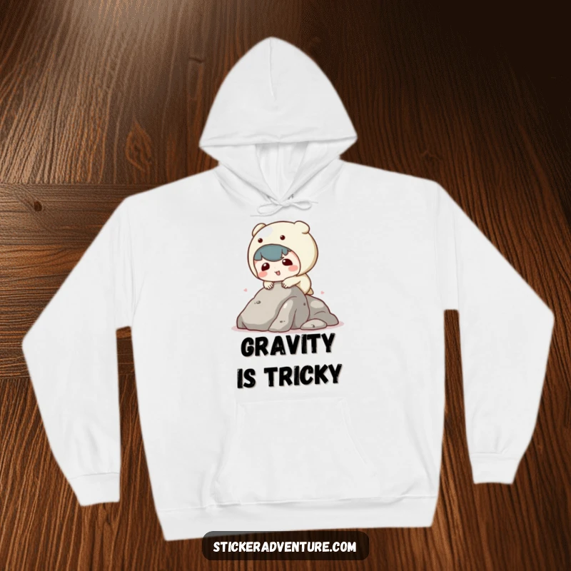 Funny kawaii character hoodie showing a clumsy character tripping while climbing, offering warmth and humorous, adorable vibes.